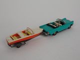 a toy boat and a toy car on a white surface