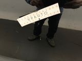 a man holding a sign that says vauto on it