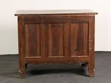 a small wooden chest with a door on top of it