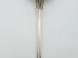 a spoon with a spoon handle on a white surface