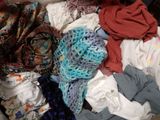 a pile of clothes sitting on top of a bed