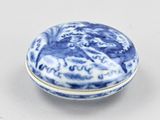 a blue and white porcelain box with a design on the lid
