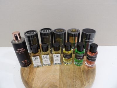 bottles of perfume are arranged on a wooden tray on a table