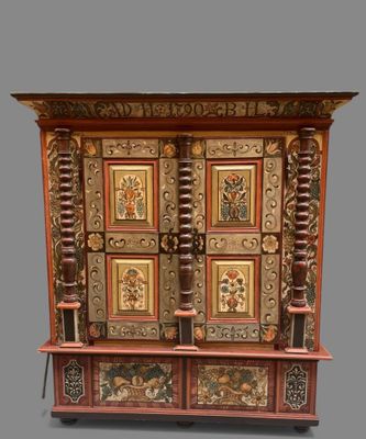 an image of a wooden cabinet with ornate designs on the doors