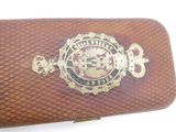 leather business card case with a gold emblem on it