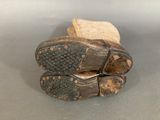 a pair of shoes that are sitting on top of a piece of wood