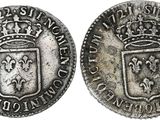 a silver coin with a crown on top of it