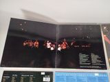 an open book with a picture of a band performing on stage