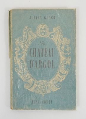 a blue book with gold writing on it on a white surface