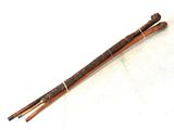 pair of wooden chopsticks on a white surface