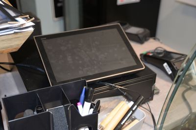 a tablet computer sitting on top of a desk next to other office supplies