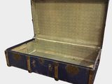 an old blue suitcase with a metal handle on a white background
