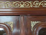 a close up of a wooden door with gold decorations
