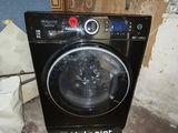 an image of a black washing machine in the corner of a room