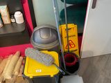a mop, bucket, bucket, and other cleaning supplies on the floor