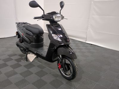the motor scooter is parked in the garage on the floor