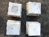 four pieces of concrete sitting on the ground next to each other