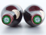 two bottles of wine sitting next to each other on a table
