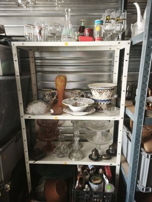 a shelf with dishes and glasses on it in a room