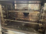 an open oven with the door open showing the inside of it