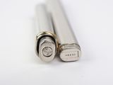 two lighters sitting side by side on a white surface