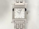 a silver watch with a white face on a silver bracelet