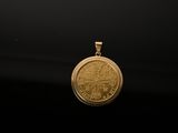 a close up of a gold coin on a black background