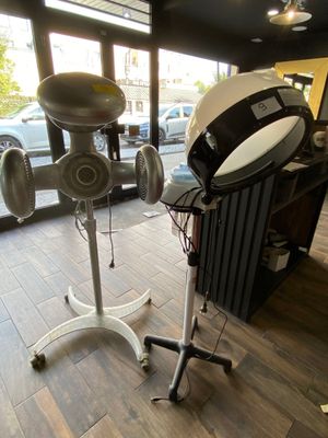 a hair dryer and a hair dryer on a stand in a room