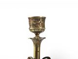 brass candle holder with two candles on a white background
