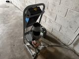 a machine that is sitting on the ground next to a wall