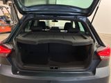 the back of a car with its trunk open in a garage