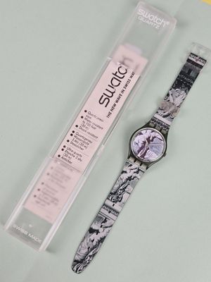 a watch that is sitting on a table next to a package
