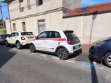 cars parked on the side of the road in front of a building