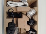 a box with a charger, a cord, and a charger plugged into it