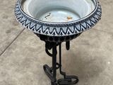 a birdbath that is sitting on a stand