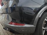 a black car parked on the side of the street