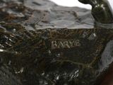a statue of a bird on a rock on a table