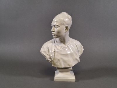 statue of a woman with a bun on her head on a white base