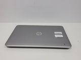the back of a laptop computer sitting on top of a white table