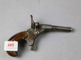 a close up of a gun on a table with a price tag on it
