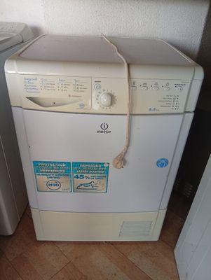 an image of a washing machine in the corner of a room