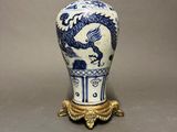 a blue and white vase with a dragon on it