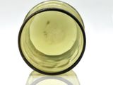 a close up of a glass bottle on a white surface