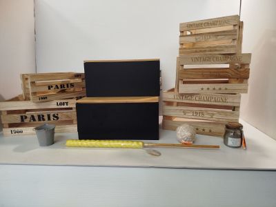 de nombreuses caisses en bois et un tableau noir posé sur une table