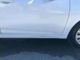 a close up of a white car parked in a parking lot