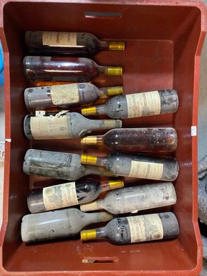 many bottles of wine in a red box on the ground