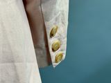 a close up of a man ' s shirt with buttons on it