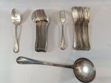 a lot of silver spoons and spoons on the table