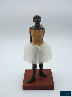statue d'une femme en tutu posée sur un socle en bois