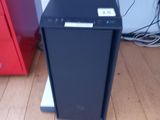 a black computer on a stand in a room